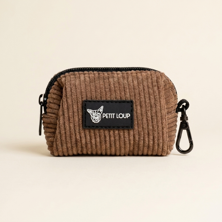 Brown corduroy pouch with a black zipper and 'PETIT LOUP' logo on a beige background